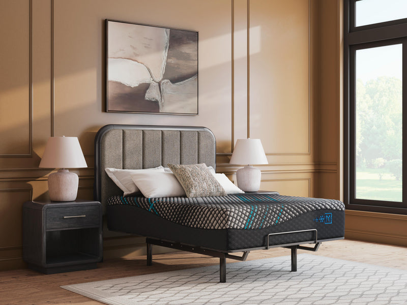 Ashley Furniture Millennium 2.0 Hybrid 16-inch mattress with a plush surface and supportive design, shown in a bedroom setting.