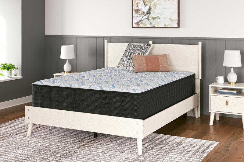 Ashley Furniture Elite Springs Plush Innerspring Mattress with quilted top and supportive coil system, shown in a bedroom setting.
