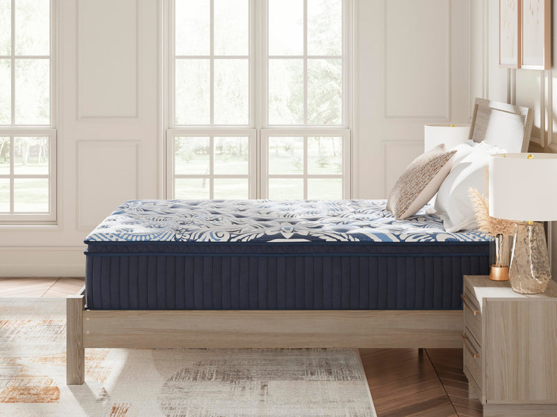 Ashley Furniture Plush Luxe 2.0 innerspring mattress with plush surface, shown in a bedroom setting.