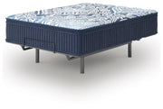 Ashley Furniture Plush Luxe 2.0 innerspring mattress shown from an angle, featuring plush surface and supportive innerspring design.