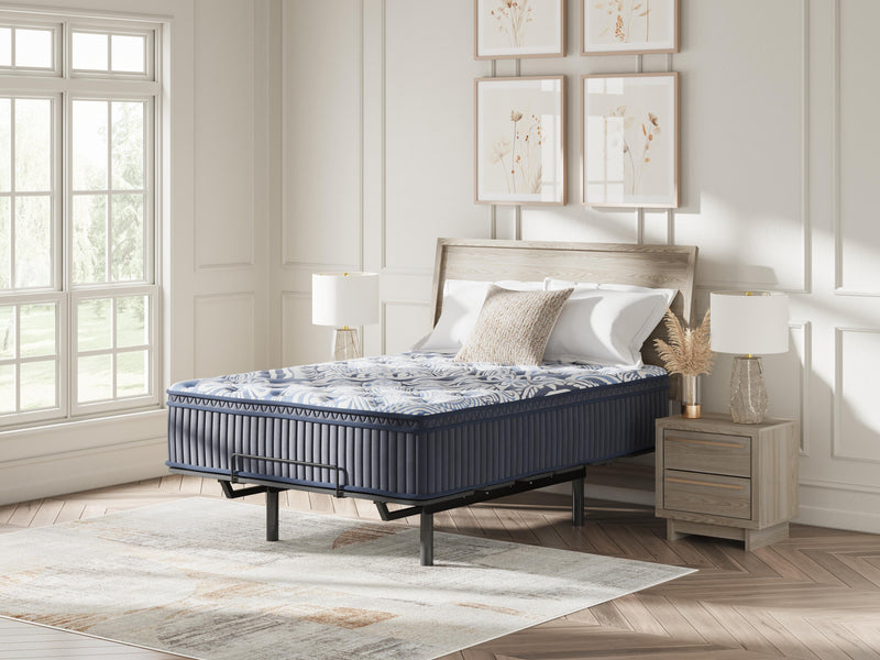 Ashley Furniture Plush Luxe 2.0 innerspring mattress with plush comfort and supportive coils, shown in a well-made bed setup.