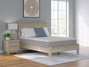 Ashley Furniture Terra Sleep Firm Hybrid Mattress showing a neatly made bed with white bedding and a supportive, firm mattress surface.