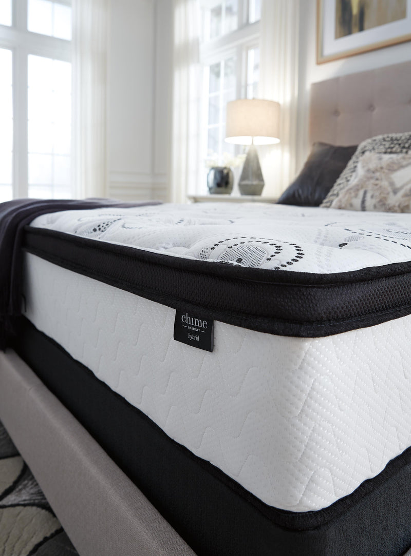 Ashley Furniture 12-inch hybrid mattress in a box with foam and coil layers, shown in a detailed view.
