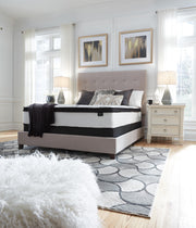 Ashley Furniture Chime 12-inch hybrid mattress in a box, showcasing the plush, supportive surface with a modern design.