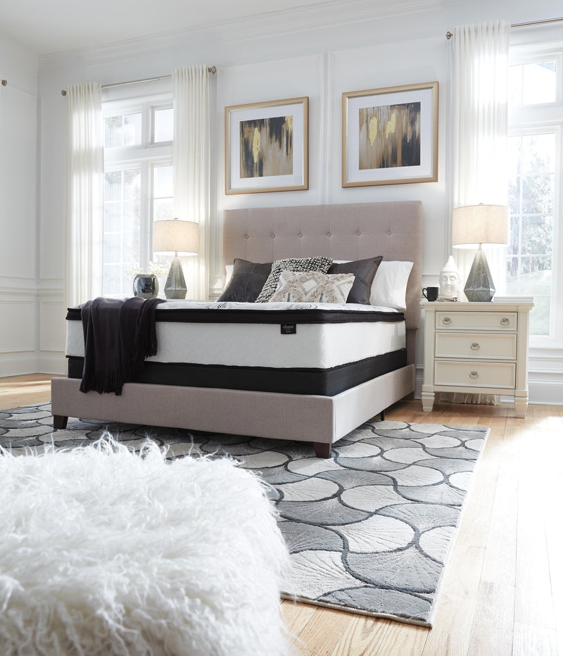 Ashley Furniture Chime 12-inch hybrid mattress in a box, showcasing the plush, supportive surface with a modern design.