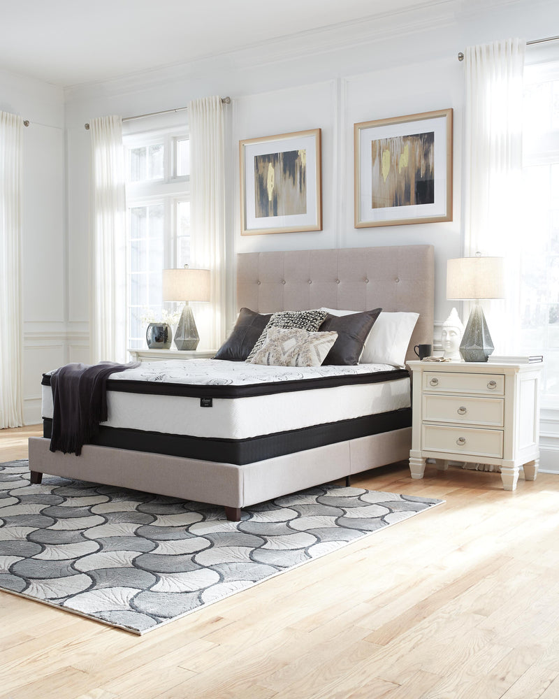 Ashley Furniture Chime 12-inch hybrid mattress in a box, showing the neatly rolled mattress with fabric cover and packaging.