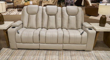 Ashley Furniture Elevate Edges reclining sofa with built-in drop-down table, shown in a modern living room setting.