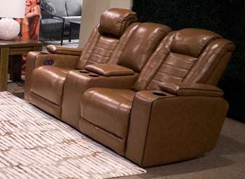 Ashley Furniture Gruaro power reclining loveseat with console, featuring plush upholstery and built-in cup holders.