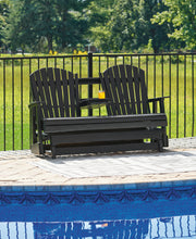 Ashley Furniture Hyland Wave outdoor loveseat glider with cushioned seating and a wave-design metal frame for outdoor relaxation.