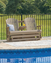 Ashley Furniture Hyland Wave outdoor glider loveseat with plush cushions and a stylish design, perfect for patio relaxation.