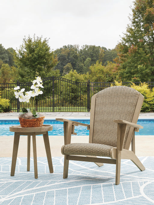 Outdoor table set from Ashley Furniture's Marina Sun package, featuring a stylish outdoor table and matching chairs in a sunny setting.