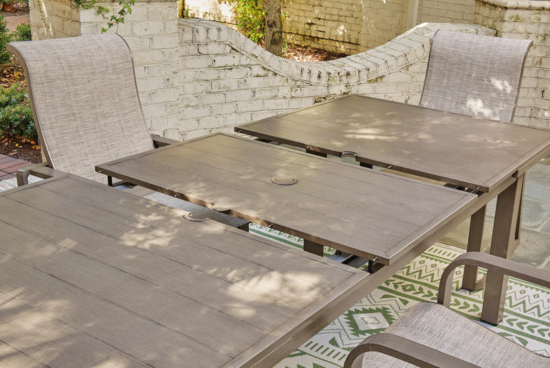 Outdoor Ashley Furniture beach front dining table with a wooden surface and sturdy legs, ideal for outdoor meals and gatherings.