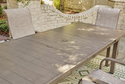 Outdoor dining table from Ashley Furniture with a natural wood finish, perfect for beach front outdoor dining spaces.