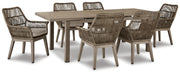 Outdoor dining set by Ashley Furniture with a table and chairs, set on a beach front patio with a scenic ocean view.