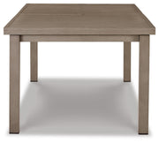 Ashley Furniture outdoor dining table with a wooden top and metal legs, designed for beach front outdoor dining spaces.