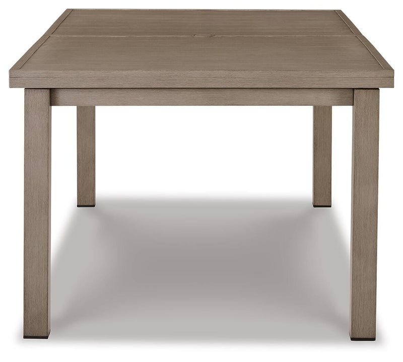 Ashley Furniture outdoor dining table with a wooden top and metal legs, designed for beach front outdoor dining spaces.