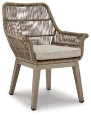 Outdoor dining set by Ashley Furniture featuring a beach front design with a table and chairs for outdoor gatherings.
