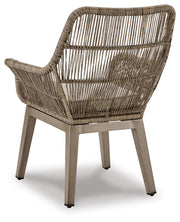 Set of two Ashley Furniture outdoor dining beach front arm chairs with cushions, featuring a sturdy frame and comfortable seating.