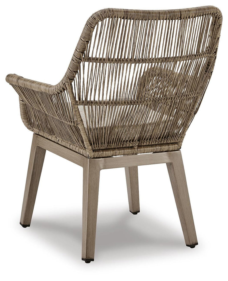 Set of two Ashley Furniture outdoor dining beach front arm chairs with cushions, featuring a sturdy frame and comfortable seating.