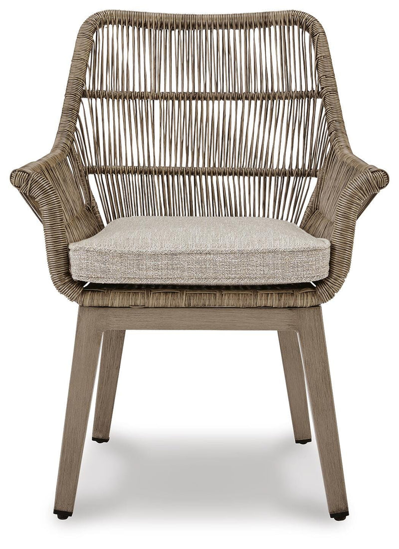 Set of two Ashley Furniture outdoor beach front arm chairs with cushions, featuring woven rattan design and sturdy metal frames.