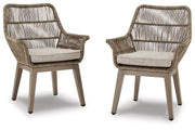 Set of two Ashley Furniture outdoor dining chairs with cushioned seats and armrests, designed for beach front outdoor relaxation.