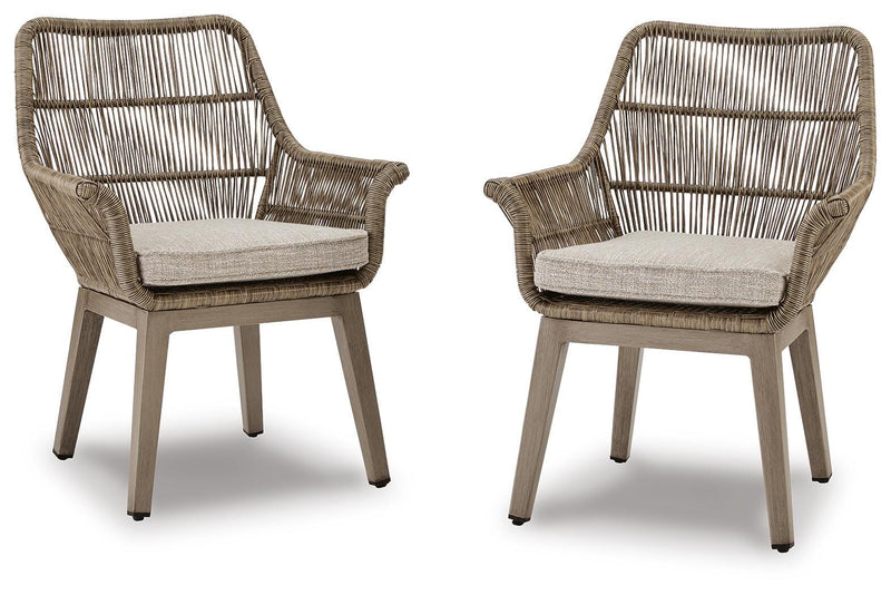 Set of two Ashley Furniture outdoor dining chairs with cushioned seats and armrests, designed for beach front outdoor relaxation.