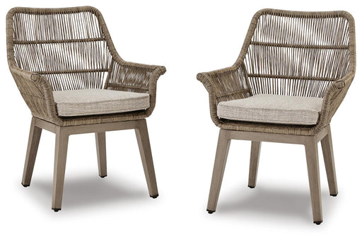Set of two Ashley Furniture outdoor dining chairs with cushioned seats and armrests, designed for beach front outdoor relaxation.