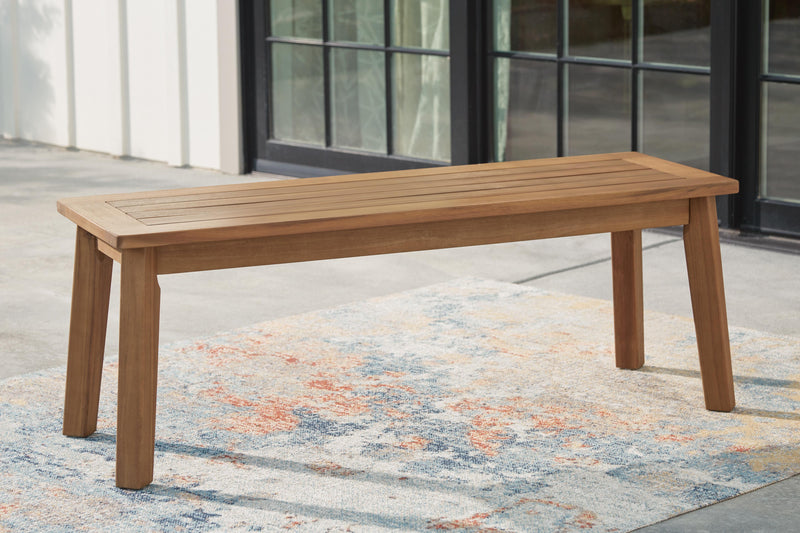 Outdoor dining bench by Ashley Furniture with wooden slats and sturdy metal legs, designed for patio or garden seating.