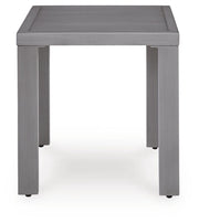 Ashley Furniture Half Moon Beach outdoor end table with a round wooden top and metal legs, perfect for patio or garden use.