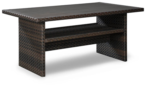 Angle view of Ashley Furniture Easy Isle multi-use outdoor dining table, showcasing its sturdy design and spacious surface.