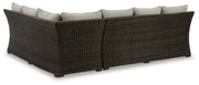 Ashley Furniture outdoor sectional with three benches and cushions, shown from the back with a modern design and sturdy frame.