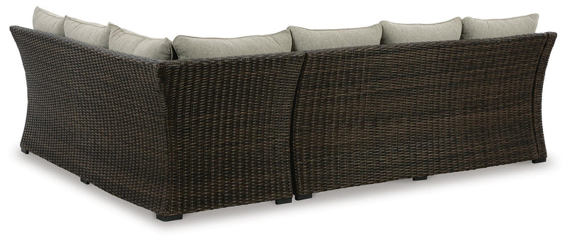 Ashley Furniture outdoor sectional with three benches and cushions, shown from the back with a modern design and sturdy frame.
