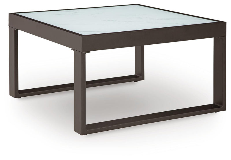 Ashley Furniture Beachloft outdoor seating set with a sofa, armchair, and coffee table in a stylish patio setting.