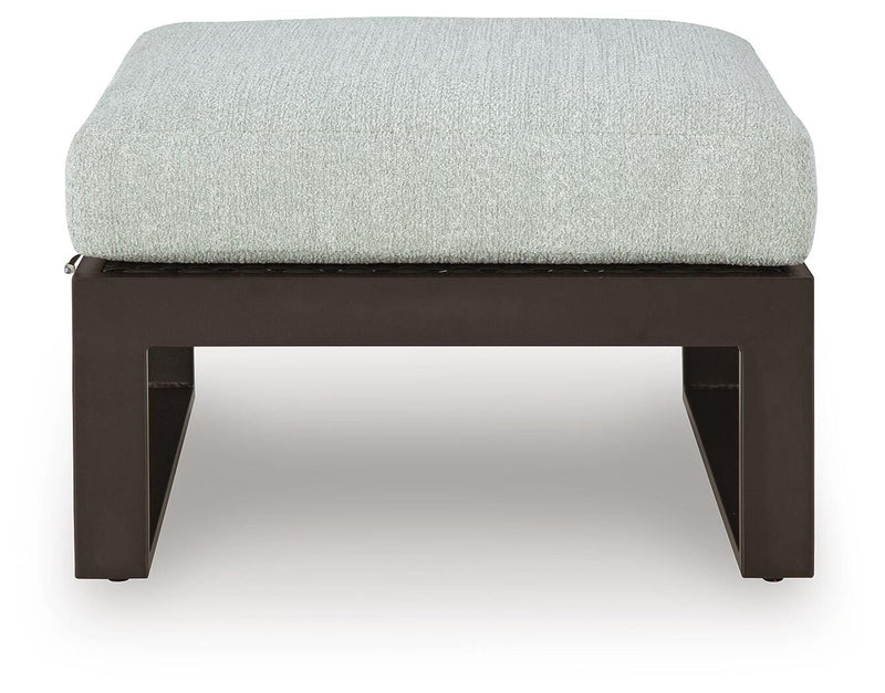 Ashley Furniture Beachloft outdoor sectional with beige cushions and wicker frame, designed for comfortable outdoor lounging.