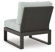 Outdoor sectional sofa by Ashley Furniture with plush cushions and weather-resistant rattan, perfect for patio lounging.