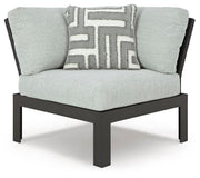 Ashley Furniture Beachloft outdoor sectional with plush cushions and wicker frame, designed for stylish outdoor lounging.