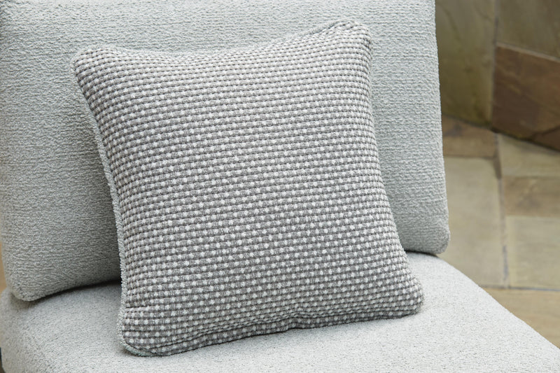 Outdoor sectional with plush pillows from Ashley Furniture's Beachloft collection, featuring a cozy seating arrangement and stylish cushions.