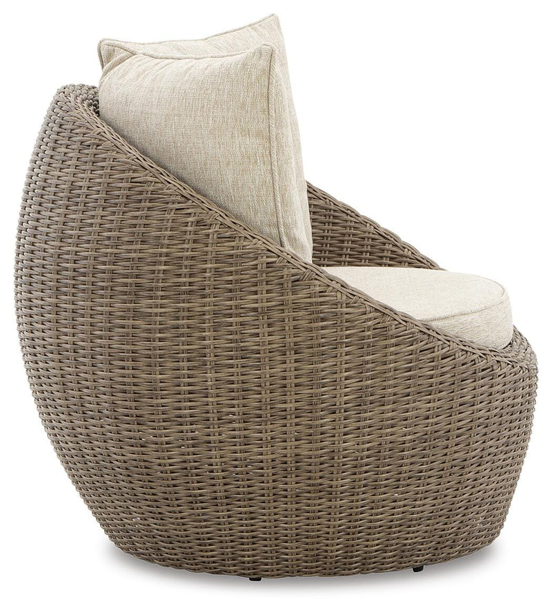 Two Ashley Furniture Danson swivel outdoor lounge chairs with cushions, shown side view in a modern outdoor setting.
