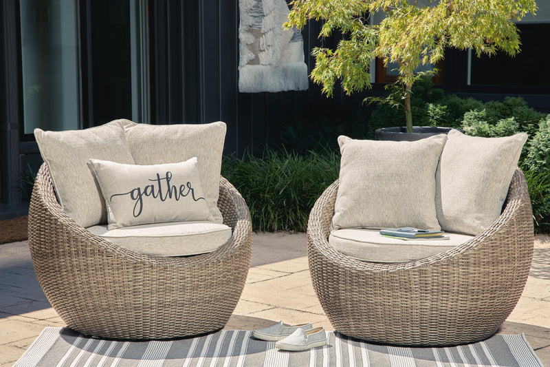 Pair of Ashley Furniture Danson swivel outdoor lounge chairs with cushions, featuring modern design and comfortable seating.