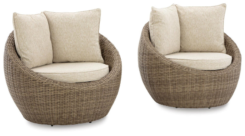 Set of two Ashley Furniture Danson swivel outdoor lounge chairs with cushions, featuring metal frames and comfortable seating.