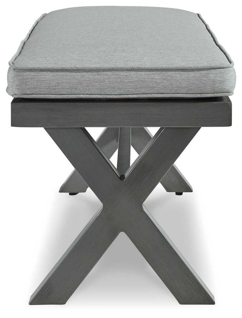 Outdoor dining bench with cushion from Ashley Furniture, featuring a sturdy wooden frame and comfortable seating for outdoor spaces.