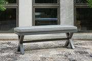 Outdoor dining bench by Ashley Furniture with a cushioned seat, ideal for outdoor patio or garden seating.
