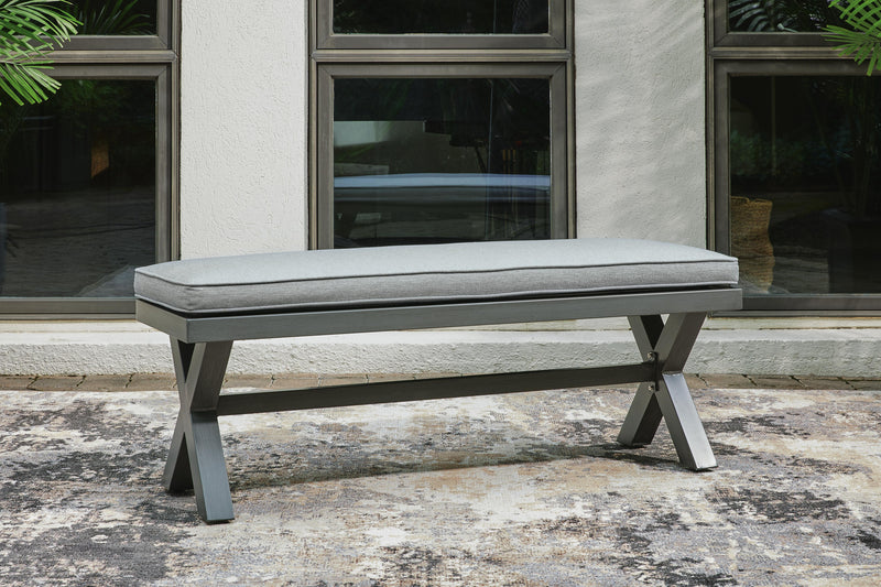 Outdoor dining bench by Ashley Furniture with a cushioned seat, ideal for outdoor patio or garden seating.