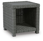 Outdoor table set by Ashley Furniture with two round tables and matching chairs, perfect for outdoor gatherings.