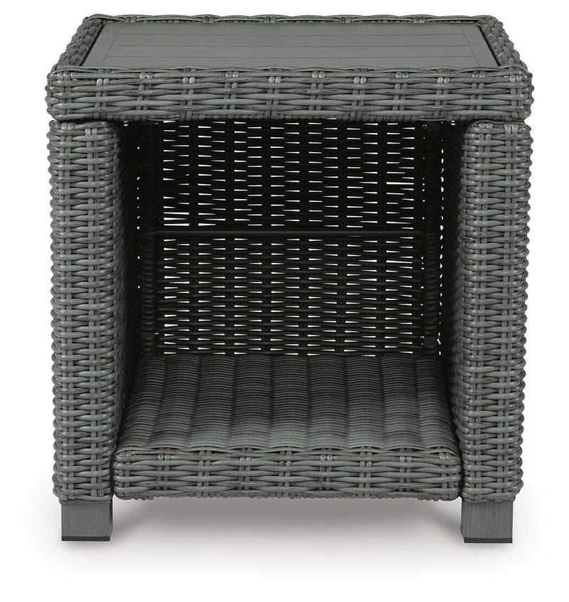 Outdoor table set by Ashley Furniture with a round table and matching chairs, suitable for outdoor seating and gatherings.