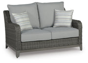 Ashley Furniture Elite Park outdoor loveseat with cushion, featuring weather-resistant design and comfortable seating for outdoor spaces.