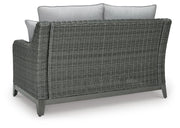 Outdoor loveseat with cushion from Ashley Furniture, featuring a sturdy frame and comfortable seating for outdoor relaxation.