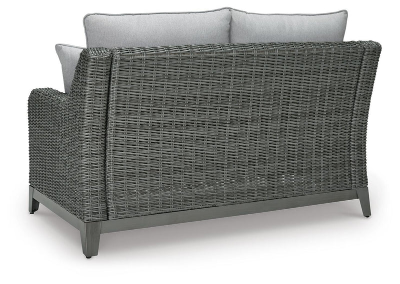 Outdoor loveseat with cushion from Ashley Furniture, featuring a sturdy frame and comfortable seating for outdoor relaxation.