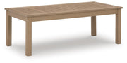 Outdoor cocktail table from Hallow Creek collection by Ashley Furniture, showing a stylish wooden surface and sturdy legs.