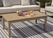 Ashley Furniture Hallow Creek outdoor cocktail table with a rustic wooden top and metal frame, ideal for patio or garden seating areas.